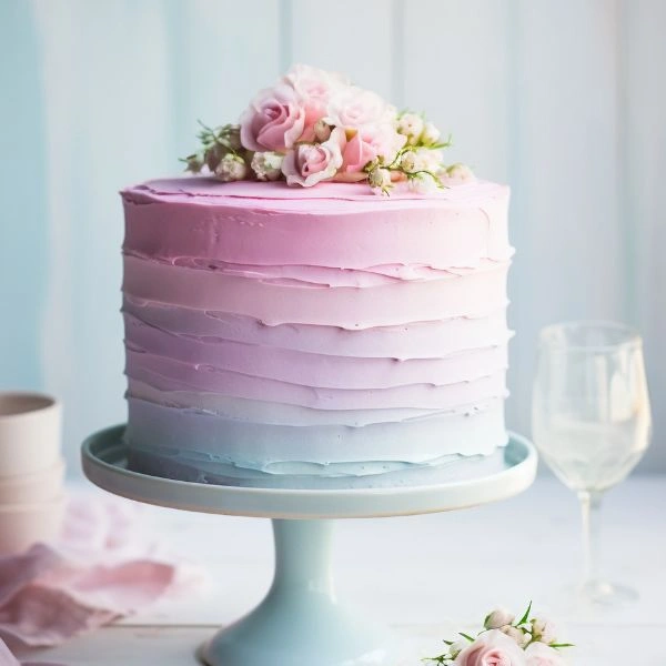 Freshly baked chocolate birthday cake with "Happy Birthday" topper, available for same-day delivery in Lucknow.